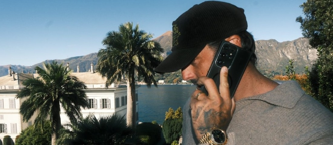 Kieran Quinlan on the phone at Lake Como